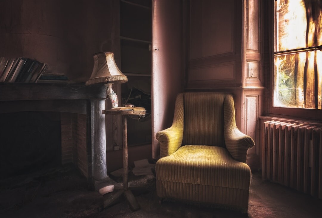 Book cover illustration of an empty chair by a window for a detective novel titled El Testigo Silencioso